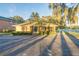 Single-story home with screened porch and lush landscaping at 1465 Riviera Dr, Kissimmee, FL 34744