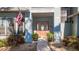 Front entrance with wood door, potted plants, and American flag at 1465 Riviera Dr, Kissimmee, FL 34744