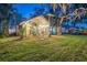 Back exterior of two-story house with patio and yard at 1465 Riviera Dr, Kissimmee, FL 34744