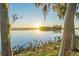 Sunrise over calm lake; tranquil waterfront property at 1465 Riviera Dr, Kissimmee, FL 34744