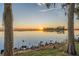 Scenic sunset view over calm lake with cypress trees in foreground at 1465 Riviera Dr, Kissimmee, FL 34744