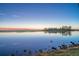 Serene lake view at sunset with a clear sky at 1465 Riviera Dr, Kissimmee, FL 34744