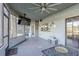 Screened porch with a large TV and outdoor seating at 1465 Riviera Dr, Kissimmee, FL 34744