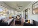 Relaxing screened porch with lake view, comfy seating, and ceiling fan at 1465 Riviera Dr, Kissimmee, FL 34744