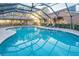 Inviting community pool with a screened enclosure at 1465 Riviera Dr, Kissimmee, FL 34744