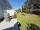 Small backyard with a grill and some trees at 1861 Roosevelt Pl, Saint Cloud, FL 34769