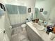 Clean bathroom with tub shower combo, vanity, and toilet at 1861 Roosevelt Pl, St Cloud, FL 34769