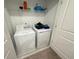 Laundry closet with washer and dryer, and overhead shelving at 1861 Roosevelt Pl, St Cloud, FL 34769