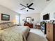 Bedroom featuring a ceiling fan, large windows, and a comfortable sitting area at 1940 Banner Ln, St Cloud, FL 34769