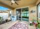 Covered patio with ceiling fan and sliding glass door at 1940 Banner Ln, Saint Cloud, FL 34769