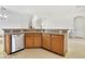 Kitchen island with stainless steel dishwasher and light wood cabinets at 2101 Bunker View Ct, Kissimmee, FL 34746