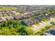 Aerial view of neighborhood with houses and trees at 241 Granada Ln, Davenport, FL 33837