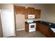 View of a kitchen with wood cabinets, a microwave, and an electric stove at 2642 Rutledge Ct, Winter Haven, FL 33884