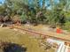 Aerial view of an animal enclosure with a small barn and pens at 2801 S Granada Blvd, Kissimmee, FL 34746