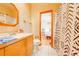 Small bathroom with shower/tub combo and wood vanity at 2801 S Granada Blvd, Kissimmee, FL 34746