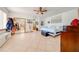 Spacious bedroom with a large bed, ceiling fan, and mirrored closet doors at 2801 S Granada Blvd, Kissimmee, FL 34746