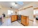 Kitchen with island, wood cabinets, and granite countertops at 2801 S Granada Blvd, Kissimmee, FL 34746