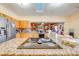 Granite countertop kitchen island with cooktop and modern appliances at 2801 S Granada Blvd, Kissimmee, FL 34746