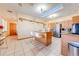 Bright kitchen features wood cabinets, granite counters, and a breakfast bar at 2801 S Granada Blvd, Kissimmee, FL 34746