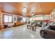 Large living room with wood ceiling, tiled floors, and a view into the kitchen at 2801 S Granada Blvd, Kissimmee, FL 34746
