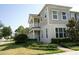 Tan two-story house with front porch and manicured lawn at 2900 Windmill Dr, Kissimmee, FL 34741