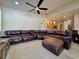 Relaxing living room featuring a large sectional sofa and ceiling fan at 2906 Vista Ct, Kissimmee, FL 34744