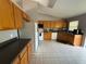 Kitchen boasts ample wood cabinets and a large refrigerator at 308 Coventry Estates Blvd, Deltona, FL 32725