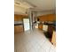 Kitchen with wood cabinets, tile floors, and white appliances at 308 Coventry Estates Blvd, Deltona, FL 32725