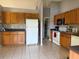 Bright kitchen with wood cabinets and white appliances at 308 Coventry Estates Blvd, Deltona, FL 32725