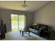Living room features a lake view and comfortable leather couch at 308 Coventry Estates Blvd, Deltona, FL 32725