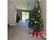Spacious living room with view of lake and decorated Christmas tree at 308 Coventry Estates Blvd, Deltona, FL 32725