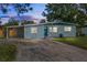 House exterior at dusk showcasing teal accents and landscaping at 405 Poinciana Cir, Kissimmee, FL 34744