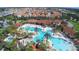 Aerial view of community pool, water park, and homes at 4191 Oaktree Drive, Davenport, FL 33837
