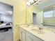 Bright bathroom with double vanity and view of bedroom at 4191 Oaktree Drive, Davenport, FL 33837