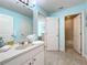 Light blue bathroom with single vanity and shower at 4191 Oaktree Drive, Davenport, FL 33837