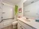 Bathroom with tub shower combination and green curtain at 4191 Oaktree Drive, Davenport, FL 33837