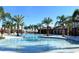Resort-style pool with palm trees and community clubhouse at 4191 Oaktree Drive, Davenport, FL 33837