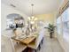 Elegant dining room with a large table, chandelier, and ample natural light at 4191 Oaktree Drive, Davenport, FL 33837