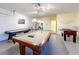 Fun game room with pool table, foosball, and air hockey at 4191 Oaktree Drive, Davenport, FL 33837