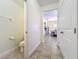 Clean hallway bathroom with toilet and view of dining room at 4191 Oaktree Drive, Davenport, FL 33837