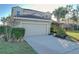 Two-story house with attached garage and landscaping at 4191 Oaktree Drive, Davenport, FL 33837