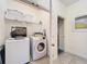 Convenient laundry room with washer, dryer, and shelving at 4191 Oaktree Drive, Davenport, FL 33837