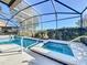 Screened pool and spa with lounge chairs for relaxing at 4191 Oaktree Drive, Davenport, FL 33837