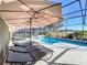 Enjoy the sun on comfy loungers by the refreshing pool at 4191 Oaktree Drive, Davenport, FL 33837