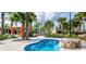 Relaxing spa pool surrounded by palm trees and landscaping at 4191 Oaktree Drive, Davenport, FL 33837