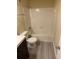 Clean bathroom with a bathtub, toilet and wood-look floors at 4728 Walden Cir # 37, Orlando, FL 32811