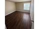 Bright bedroom with laminate wood flooring at 4728 Walden Cir # 37, Orlando, FL 32811