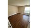 Spacious bedroom with dark laminate flooring at 4728 Walden Cir # 37, Orlando, FL 32811