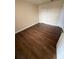 Well-lit bedroom with wood-look floors and closet at 4728 Walden Cir # 37, Orlando, FL 32811