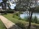 Landscaped walkway alongside a lake with fountain at 4728 Walden Cir # 37, Orlando, FL 32811